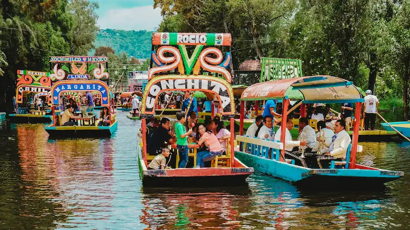 A photo of many trajineras on the canals at Xochimilco
